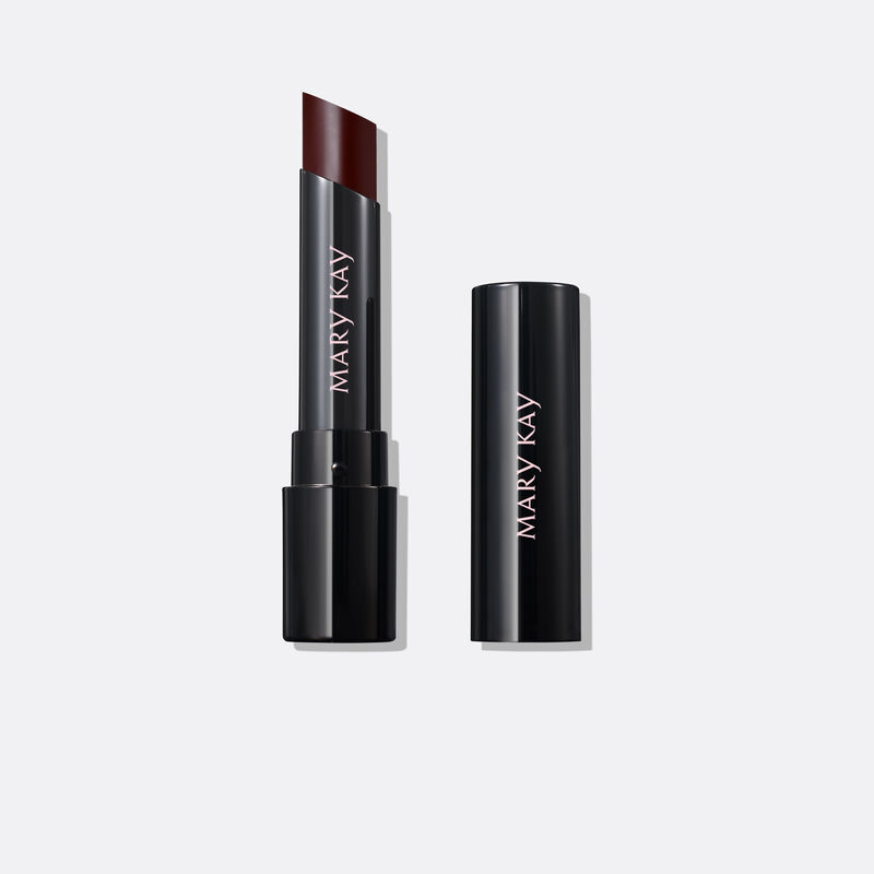Uncapped tube of Mary Kay Supreme Hydrating Lipstick in shade Black Cherry next to accompanying cap against plain background.